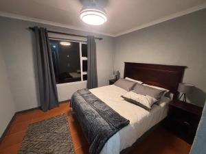 a bedroom with a large bed and a window at Paradise Cove Marina in Jeffreys Bay