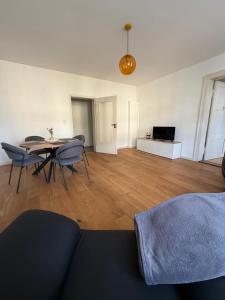 a living room with a table and chairs and a television at Dianas Ferienwohnung 2 in Feldberg