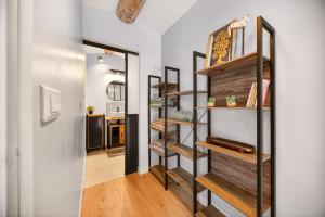 a room with wooden shelves and a hallway at Pigeonnier de charme in Villefranche-de-Lauragais
