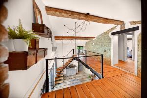 a staircase in a house with wooden floors at Pigeonnier de charme in Villefranche-de-Lauragais