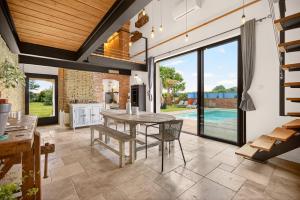 an open living room with a table and chairs at Pigeonnier de charme in Villefranche-de-Lauragais +21 photos