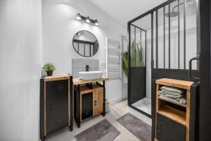 a bathroom with a sink and a mirror at Pigeonnier de charme in Villefranche-de-Lauragais