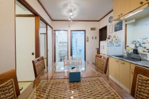 a kitchen with a table and chairs and a refrigerator at Green Hights Residence-107 in Naha