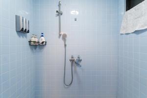 a bathroom with a shower with blue tiles at Green Hights Residence-107 in Naha +28 photos