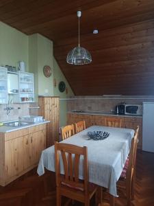 a kitchen with a table and a kitchen with a sink at Anna Vendégház in Hévíz