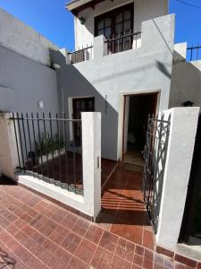 a white house with a gate in front of it at Casita de Norma, Mercedes Corrientes!!! in Mercedes