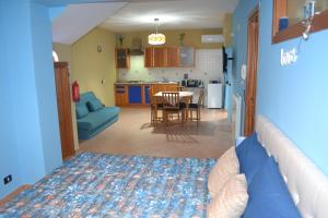 a bedroom with a bed and a kitchen with a table at B&B La Casa di Gastone in Mercogliano