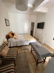 a bedroom with a bed and a table in it at Casita de Norma, Mercedes Corrientes!!! in Mercedes