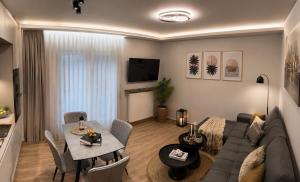 a living room with a couch and a table at Sea & Sun Luxury Apartment in Alexandroupoli
