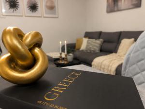 a gold pretzel sitting on top of a book at Sea & Sun Luxury Apartment in Alexandroupoli