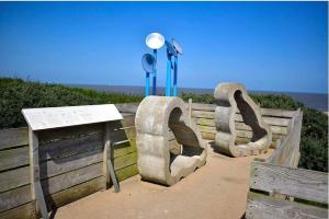 a sculpture of the word ego on a fence at GnT Caravan lets in Anderby