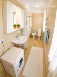a bathroom with a sink and a washing machine at Casa Francesca - Agenzia Cocal in Caorle