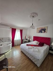 a bedroom with a large bed and a bath tub at Villa Yazır in Antalya