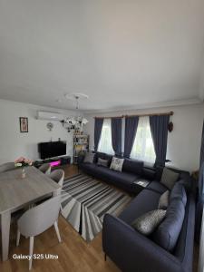 a living room with a couch and a table at Villa Yazır in Antalya