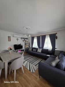 a living room with a couch and a table at Villa Yazır in Antalya