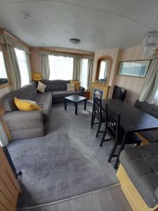 a living room with a couch and a table at GnT Caravan lets in Anderby