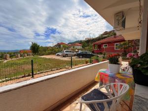 a balcony with a table and a view of a street at Mert Jacellari Guesthouse in Pogradec