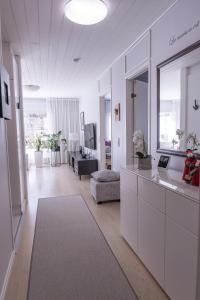 a living room with white cabinets and a room with a couch at Villa White Star in Rovaniemi