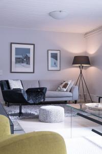 a living room with a couch and a table at Villa White Star in Rovaniemi