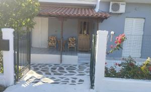 a gate to a house with a table and chairs at Victoria's Summer House in Amalias