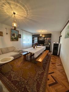a living room with a table and a couch at Etno Kuća Jaćimović 1 in Pranjani