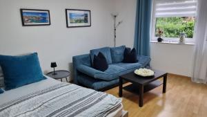a bedroom with a bed and a couch and a chair at Ulli's Oase in Uettingen
