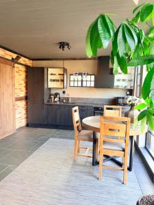 a dining room with a table and chairs and a kitchen at Parkside studio in Hjo +3 photos