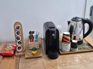 a coffee maker sitting on top of a table at בית המזל Fortune House in Bet Sheʼan