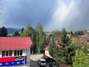 a car parked in front of a house at Cozy Urban Apartment in Câmpulung