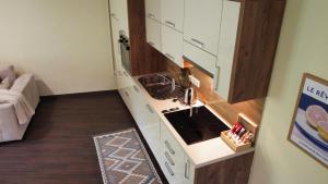 a small kitchen with a stove and a sink at Layal Residence Exclusive 2 Floor House with Terrace in Bihać