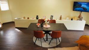a dining room with a table and orange chairs at Layal Residence Exclusive 2 Floor House with Terrace in Bihać