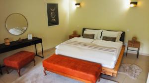 a bedroom with a bed and a table and a mirror at Layal Residence Exclusive 2 Floor House with Terrace in Bihać
