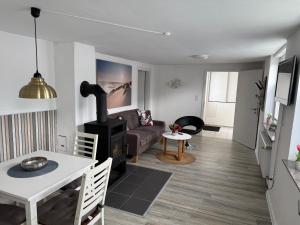 a living room with a couch and a stove at Ferienapartment Stemmert in Gelting