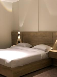a bedroom with a large bed with two pillows at Alraha Resort in Aqaba