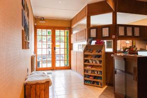 a kitchen with wooden cabinets and a counter top at Hostal Don Guillermo in Puerto Natales