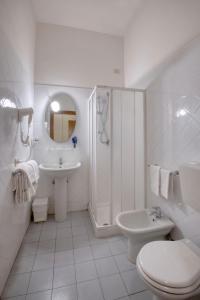 a white bathroom with a toilet sink and a shower at Albergo La Posta Arezzo in Badia Al Pino +48 photos