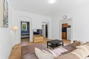 a living room with a couch and a tv at Panorama Apartments an der Seilbahn unterhalb der Albrechtsburg - Parkplatz und Wi-Fi - FREE in Meißen
