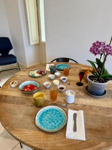 a wooden table with plates of food on it at La Belle Eclusière in Homps