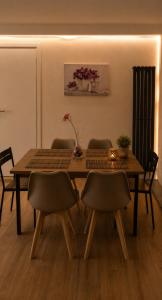 a dining room table with chairs and a wooden table at Spa & Relax in Cairo Montenotte