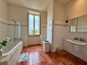 a bathroom with a bath tub and a sink at La Belle Eclusière in Homps +37 photos