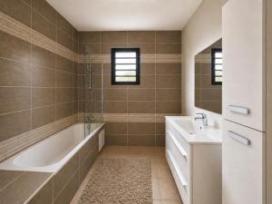 a bathroom with a tub and a sink at Le P'tit Rubis in Le Tampon +14 photos