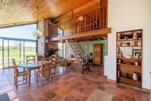 a dining room with a staircase and a table and chairs at Petit Clos d'Hélix in Annay-sur-Serein