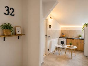 a kitchen with a table and a washing machine at Powidz Work & Stay in Powidz