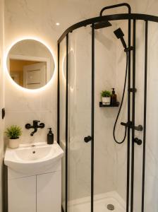 a bathroom with a shower and a sink at Powidz Work & Stay in Powidz