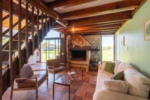 a living room with a couch and a fireplace at Petit Clos d'Hélix in Annay-sur-Serein