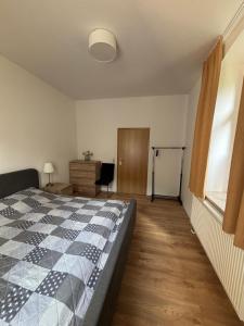 a bedroom with a bed and a desk and a window at Waldvilla in Bad Schandau