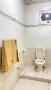 a bathroom with a toilet and a towel at Comfort Inn in Chitral