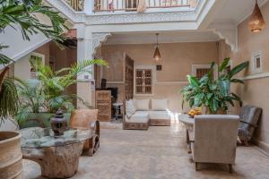 a living room filled with furniture and plants at Riad MISS CARACAL Jacuzzi & Rooftop in Marrakesh