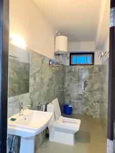 a bathroom with a toilet and a sink at Hotel khangyul in Ravangla