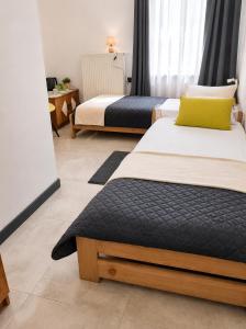 two beds in a hotel room with at Powidz Work & Stay in Powidz